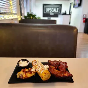 BBQ pork ribs, elote corn &amp; baked potato.