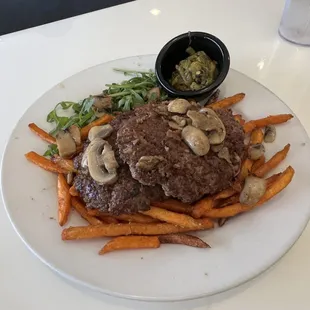 a steak and sweet potatoes on a white plate