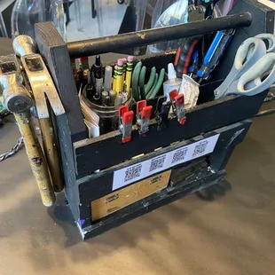 A couple sets of tool boxes at each table