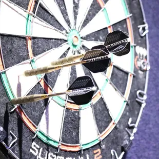 three darts in the center of a dartboard