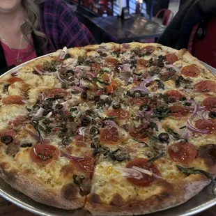 a pizza with pepperoni and onions