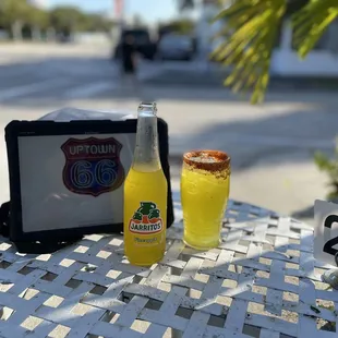 a table with a bottle and a tablet