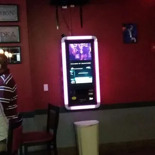 a man sitting at a table in front of a television