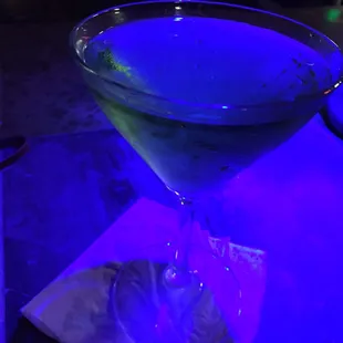 a martini with a blue light in the background