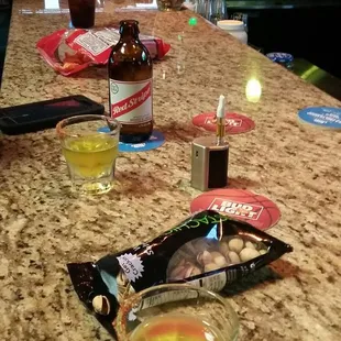a table with a drink and snacks