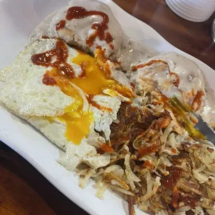 Biscuits and gravy with hash browns and sunny side up eggs, add hot sauce