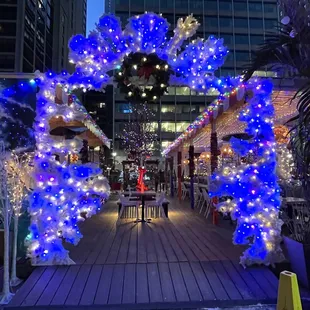 a blue archway decorated with christmas lights