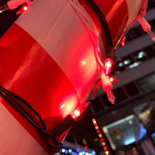 a red and white buoy decorated with christmas lights