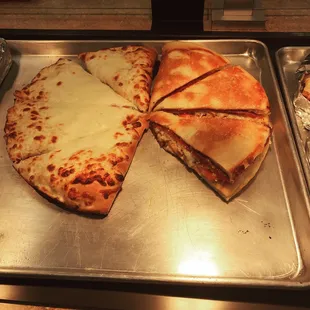 To the left is our version of a spinach pie double stuffed with spinach, red onion, feta, mozzarella cheese and tomatoes