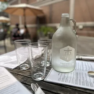 a bottle and glasses on a table
