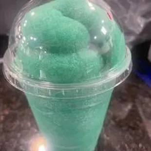 a green ice cream in a plastic cup