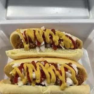 two hot dogs with mustard and ketchup