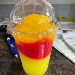 a plastic cup filled with a colorful drink