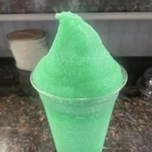 a green ice cream cone in a cup