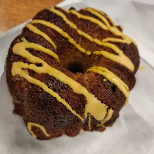 a chocolate donut with yellow icing