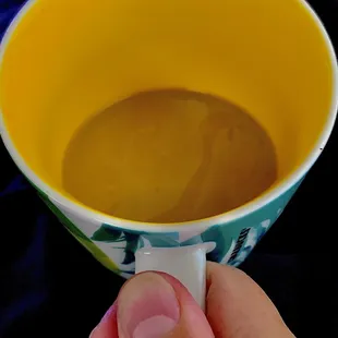 a hand holding a cup of coffee