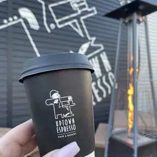 a hand holding a cup of coffee