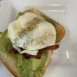 an avocado toast with an egg on top