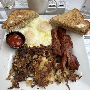 Eggs, Bacon, Hash Browns with wheat toast.