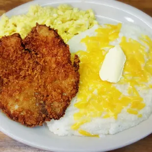 Tilapia fish and grits platter with cheddar cheese! Scrambled eggs too!