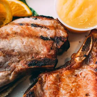 grilled pork chops with a side of oranges