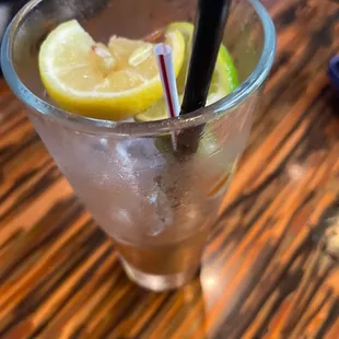 a glass of lemonade with two straws