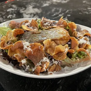 Salmon with house made  sweet potato chips, mixed greens with Pablano berry reduction and mixed greens.