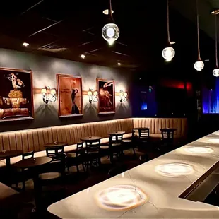 a row of tables in a dimly lit restaurant