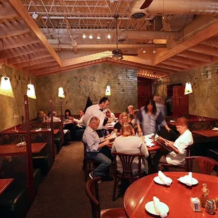 a group of people eating in a restaurant