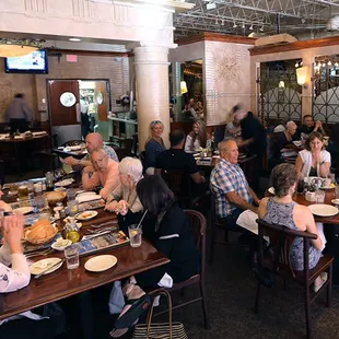 a large group of people eating at a restaurant