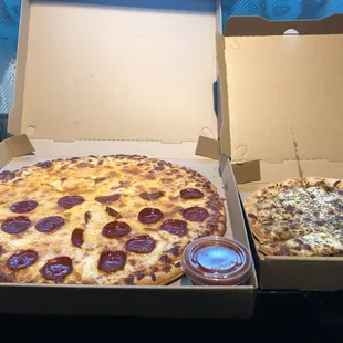 two pizzas with pepperoni and ketchup