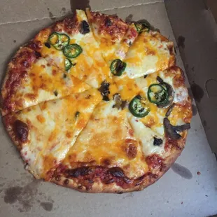 four cheese specialty pizza with added mushrooms and jalapenos on half from Uptown pizza