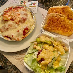 Chicken Parm dinner with salad and garlic toast