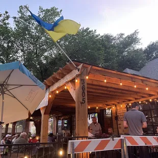 people sitting outside under umbrellas