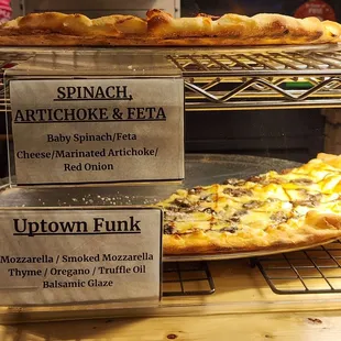 a display of a variety of pizzas