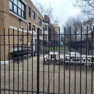 a view of the back of a building through a gate