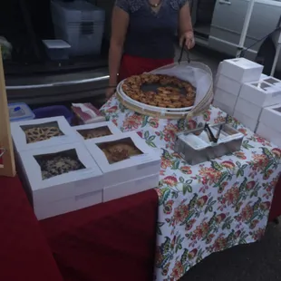 a woman standing in front of a display of food