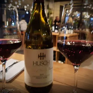 two glasses of wine and a bottle of wine
