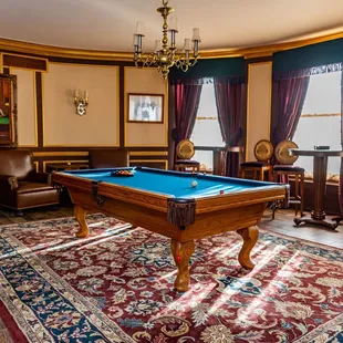 a pool table in the middle of the room