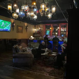 a group of people sitting around a bar