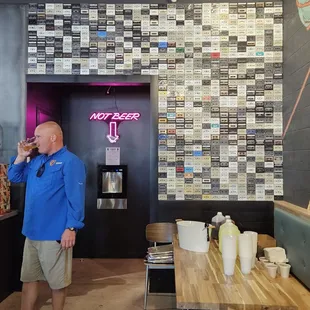 Enjoying a brew by the cassette wall.