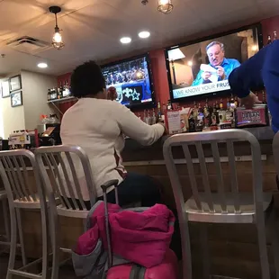 ows a woman sitting at a bar