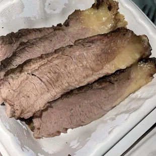 ows a person holding a container of meat