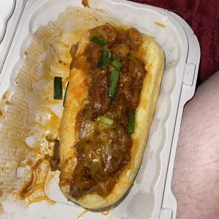 ows a hot dog in a styrofoam container