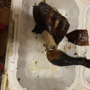 ows a half eaten fish in a styrofoam container