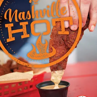  hand dipping a piece of chicken