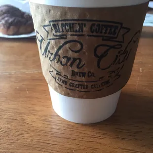 a paper cup of coffee