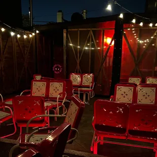 red chairs and string lights