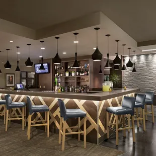 a bar with blue chairs