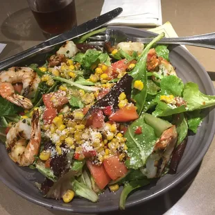 $16 for six shrimp , some green mix lettuce, corn and chopped tomatoes.